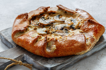 Free-form pie with mushrooms, onions and blue cheese.