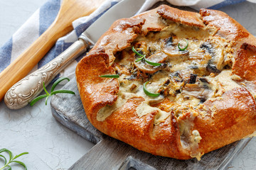 Homemade pie(galette) with mushrooms and rosemary.