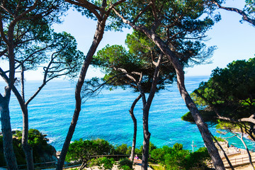 Sea view in Spain. Costa Brava holidays. Blue waves and rocks. Summertime beach.