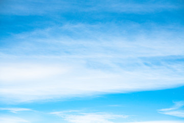 Fototapeta premium Blue bright sky with flat clouds. background with space for text