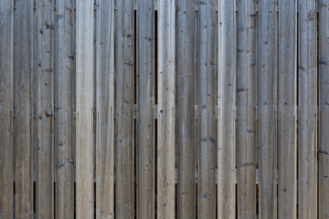 Full frame background of a gray and unpainted wood board wall