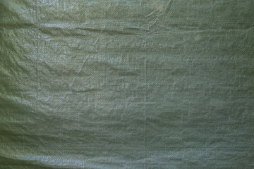 Full frame background of a wrinkled green tarp texture - obrazy, fototapety, plakaty