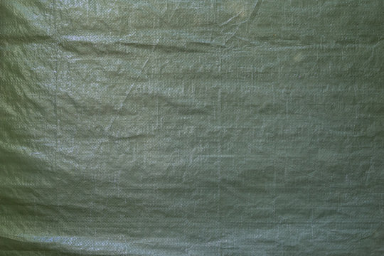 Fototapeta Full frame background of a wrinkled green tarp texture