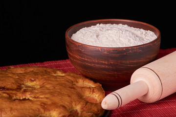 apricot pie and a bowl with flour and other ingredients and tools table