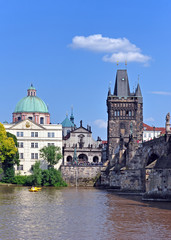 Obraz premium View from the Vltava River to Charles Bridge, the Old Town Tower and the Church of St. Francis of Assisi. Prague, Czech Republic, Europe