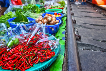 Fototapeta premium Selling food on the Maeklong Railway market in Thailand