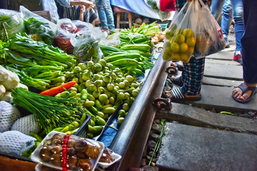 Selling food on the Maeklong Railway market in Thailand