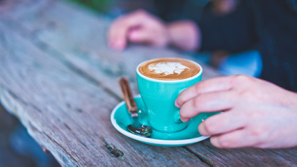 Latte hot coffee in a green cup 
