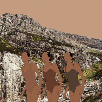 Three women in bathing suits on rocky beach