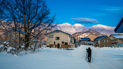 Photographer With Snow House Landscape