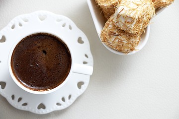 Turkish coffee with Shredded dough baked in syrup topped with crushed nuts Turkish delight top view