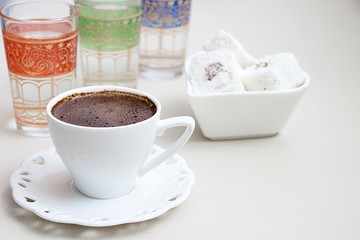Turkish coffee with milk cream chocolate pistachio Turkish delight and cup of water