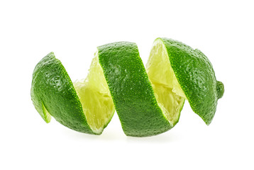 Cut lime in shape of a spiral on white background