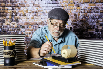 humorous picture of elderly accountant doing the books with pencil and adding machine