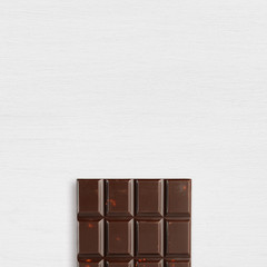 Chocolate bar on white table top view