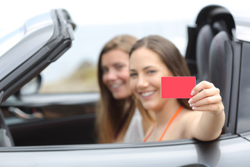 Tourists showing a blank credit card in a car