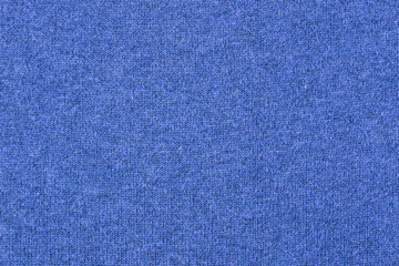 Fabric knitting wool texture blue color. Cloth knitted wool.