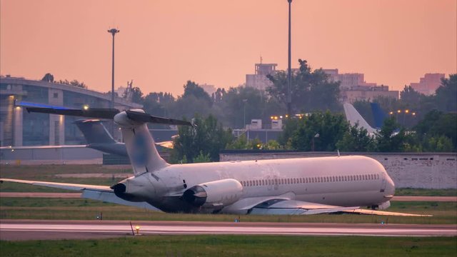 Crashed airplane after an emergency landing lies on the airfield at the airport. Time lapse. Zoom out effect