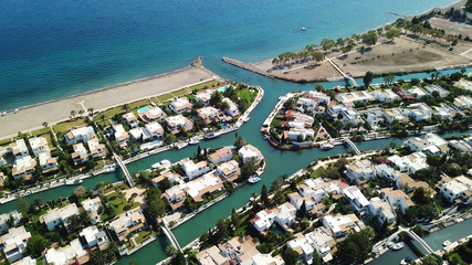 Aerial drone bird's eye view photo of famous seaside resort of Porto Hydra built on canals with boats docked resembling Venice or Miami, Peloponnese, Greece