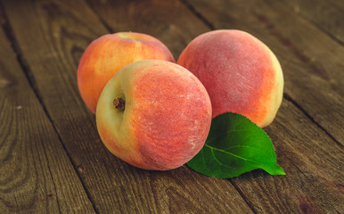 fresh peaches on wooden table