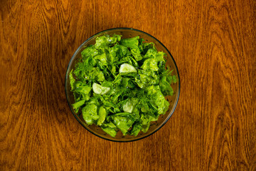 useful salad of greens and cucumbers in olive oil