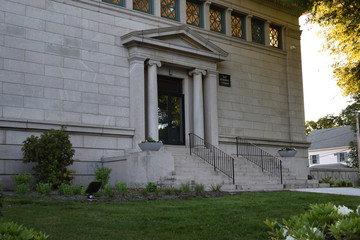 library edifice in the evening in white marble showing door and stairs with no people.