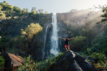 Man go to the waterfall in the forest