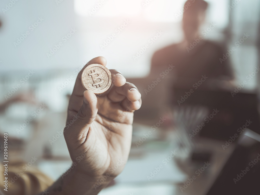 Poster close-up selective focus of hand is demonstrating bitcoin. most important cryptocurrency concept. bl