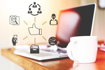 Business people are holding a smartphone and use it to check information at hand ,Businesswomen work in office using a laptop computer, job analysis and job description checking