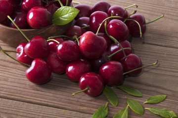 red cherries on rustic wood