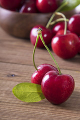 red cherries on rustic wood