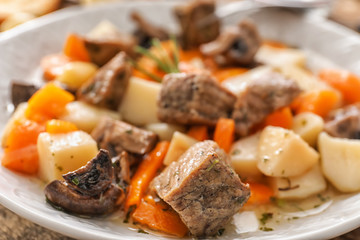 Plate with stewed meat and potatoes, closeup