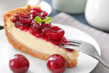 Delicious cheesecake with cherries on plate, closeup