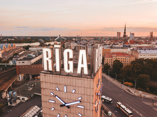 RIGA, LATVIA - JUNE 14, 20: Aerial view on the main station and shopping mall Origo clock tower...