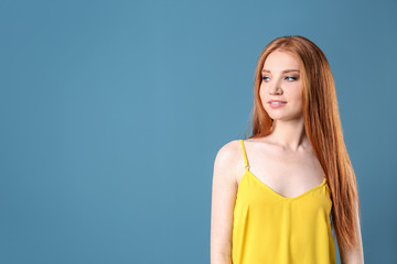 Obraz premium Portrait of young model with beautiful hair on color background