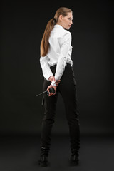 Female security guard with portable radio transmitter on dark background