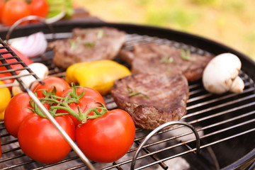 Modern grill with meat and vegetables outdoors, closeup