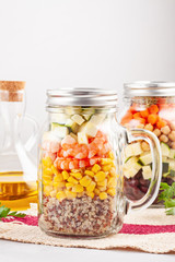 Fototapeta na wymiar Fresh homemade salad in jars with quinoa, chickpeas and organic vegetables. Healthy take away food, office lunch, vegeterian, detox diet concept.