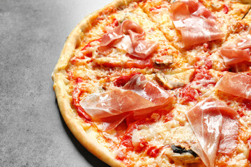 Delicious pizza with bacon on grey background