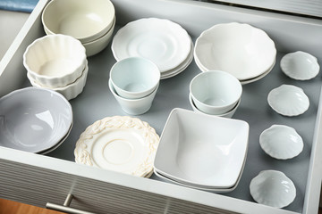 Ceramic dishware in kitchen drawer