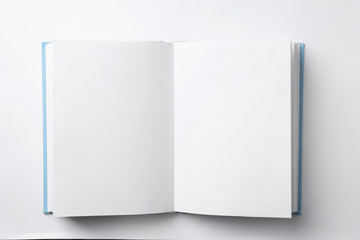 Mockup of open book on white background, top view