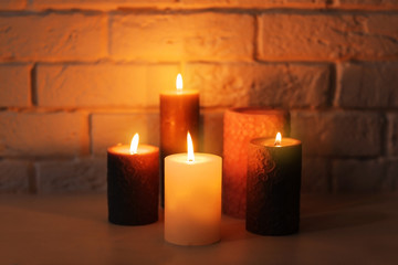 Burning candles on table indoors