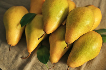 Fresh ripe pears on cloth, closeup