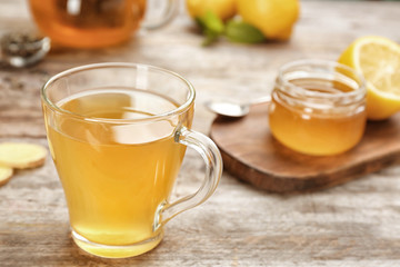 Cup with hot tea for cold on wooden table