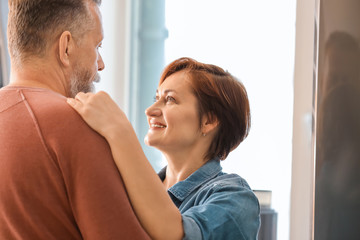 Happy mature couple dancing at home