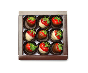 Box with chocolate covered strawberries on white background, top view