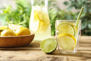 Natural lemonade with lime in glass on table