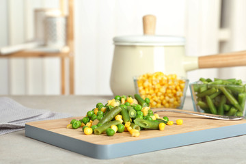 Board with mix of frozen vegetables on table