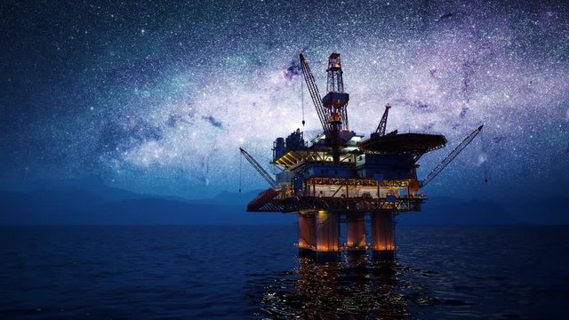 Offshore platform or oil rig in the open sea with milky way in the background.