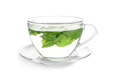 Cup with hot aromatic mint tea on white background